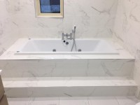 Bathroom installation in Cavan with whirlpool and marble effect tiling by North West Tiles & Timber, Ireland